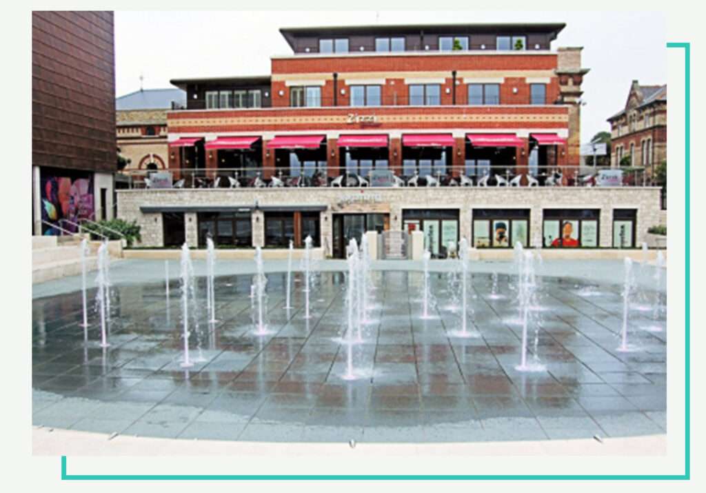 Pedestal paver system with integrated fountain allowing clean water drainage beneath pavers