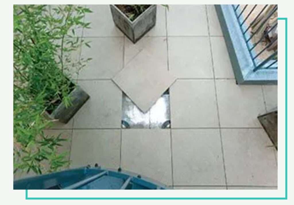Pedestal paver system with tile lifted to show simple access for maintenance and repairs